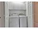 Well-organized laundry room with a washer, dryer, and built-in storage at 7309 Regina Royale Blvd # 21, Sarasota, FL 34238