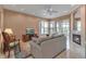 Inviting living room with fireplace, neutral tones, and views to the outside patio through sliding glass doors at 7309 Regina Royale Blvd # 21, Sarasota, FL 34238