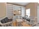 Bright living room with custom built-ins, a large mirror, and comfortable seating at 7309 Regina Royale Blvd # 21, Sarasota, FL 34238