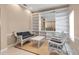 Bright living room with custom built-ins, a large mirror, and comfortable seating at 7309 Regina Royale Blvd # 21, Sarasota, FL 34238