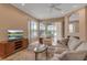Cozy living room boasts a fireplace, plush seating, and scenic views overlooking the lush green landscape at 7309 Regina Royale Blvd # 21, Sarasota, FL 34238