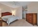 Spacious main bedroom features neutral walls, a ceiling fan, and coordinating wooden furnishings on carpeted floor at 7309 Regina Royale Blvd # 21, Sarasota, FL 34238