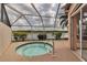 Hot tub on screened patio with a view of the lake and lush golf course at 7309 Regina Royale Blvd # 21, Sarasota, FL 34238