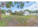 The large backyard view features a storage shed and covered patio and spans the width of the house at 807 Harbor Ave, Ellenton, FL 34222