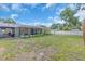 View of backyard with a patio, screened-in porch, grassy area, and white vinyl perimeter fence at 807 Harbor Ave, Ellenton, FL 34222