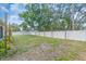 Spacious backyard features a well-maintained lawn and a pristine white vinyl fence for privacy at 807 Harbor Ave, Ellenton, FL 34222