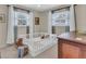 Bright bedroom with ample natural light, complemented by a white crib and a classic wooden dresser at 807 Harbor Ave, Ellenton, FL 34222