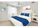 Comfortable bedroom featuring a queen-sized bed, decorative bedside tables, and sheer curtains at 807 Harbor Ave, Ellenton, FL 34222