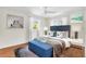 Comfortable bedroom with wood floors, bench, and decorative pillows provide a cozy setting at 807 Harbor Ave, Ellenton, FL 34222