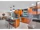 Modern kitchen with gray counters, wood cabinets, island, stainless appliances, and open concept at 807 Harbor Ave, Ellenton, FL 34222
