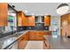 Modern kitchen with stainless steel appliances, gray counters, wood cabinets and stylish backsplash at 807 Harbor Ave, Ellenton, FL 34222