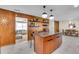 Open-concept kitchen with island, wood cabinets, pendant lighting, and views to dining and living rooms at 807 Harbor Ave, Ellenton, FL 34222