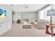 Bright living room features neutral tones, a comfortable sectional sofa and stylish marble coffee table at 807 Harbor Ave, Ellenton, FL 34222