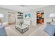 Bright living room with floating shelves provides seamless transition into the adjacent kitchen at 807 Harbor Ave, Ellenton, FL 34222