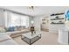 Inviting living room features floating shelves, a neutral color palette, and natural light from the window at 807 Harbor Ave, Ellenton, FL 34222