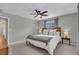 Neutral bedroom with ceiling fan, two windows, and bedside tables at 807 Harbor Ave, Ellenton, FL 34222