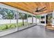 Inviting screened porch with wood ceiling, view of backyard, and comfortable seating at 807 Harbor Ave, Ellenton, FL 34222