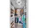 Organized walk-in closet featuring ample storage space, shelving, and a decorative light fixture at 807 Harbor Ave, Ellenton, FL 34222