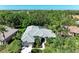 This aerial view showcases a well-maintained home with lush landscaping and a grey tile roof at 8118 Waterview Blvd, Lakewood Ranch, FL 34202