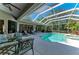 Screened-in pool area with comfortable lounge chairs and patio furniture and lush landscaping at 8118 Waterview Blvd, Lakewood Ranch, FL 34202