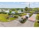 Aerial view of the community entrance showcasing lush landscaping, a gated entry, and the community signage at 8517 Buckingham Pl, Palmetto, FL 34221