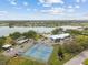 Aerial view of tennis courts, lake, pool and clubhouse in a beautiful community at 8517 Buckingham Pl, Palmetto, FL 34221
