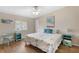Serene bedroom featuring a ceiling fan, a queen size bed, and two matching blue nightstands at 8517 Buckingham Pl, Palmetto, FL 34221