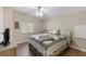 Cozy bedroom with a ceiling fan, a comfortable bed, and a tranquil ambiance at 8517 Buckingham Pl, Palmetto, FL 34221