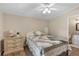 Comfortable bedroom featuring a ceiling fan, a cozy bed, and warm, inviting natural light at 8517 Buckingham Pl, Palmetto, FL 34221