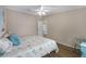 Inviting bedroom with a cozy bed, ceiling fan, and easy access to the rest of the home at 8517 Buckingham Pl, Palmetto, FL 34221