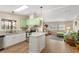 Bright, remodeled kitchen featuring granite countertops and stainless steel appliances, open to the living area at 8517 Buckingham Pl, Palmetto, FL 34221