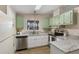 Stylish kitchen featuring granite countertops, white cabinets, and stainless steel appliances at 8517 Buckingham Pl, Palmetto, FL 34221