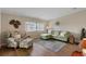 Comfortable living room with a green sofa, chair, and large windows allowing for plenty of natural light at 8517 Buckingham Pl, Palmetto, FL 34221