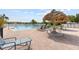 Community pool with lounge chairs, tables, and a tiki umbrella, perfect for outdoor relaxation by the water at 8517 Buckingham Pl, Palmetto, FL 34221