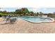 The community pool area features comfortable lounge chairs and tables for outdoor relaxation, overlooking the water at 8517 Buckingham Pl, Palmetto, FL 34221
