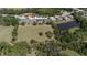 Aerial shot of a home surrounded by greenery and a picturesque pond at 8615 59Th E St, Parrish, FL 34219
