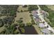 Lush aerial view of a home nestled near a pond and ample green space at 8615 59Th E St, Parrish, FL 34219