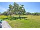 Spacious backyard featuring lush green grass and mature trees for added privacy at 8615 59Th E St, Parrish, FL 34219