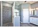 Relaxing bathroom featuring a stylish vanity with a marble countertop and sleek, pebble-stone shower at 8615 59Th E St, Parrish, FL 34219