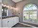 Bright bathroom features double sinks, granite countertops, and a large arched window at 8615 59Th E St, Parrish, FL 34219