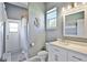 Bright and airy bathroom with a white vanity, classic fixtures, and shower near the exterior door at 8615 59Th E St, Parrish, FL 34219