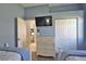Bright bedroom with a TV, closet, and dresser providing ample storage space, next to a doorway at 8615 59Th E St, Parrish, FL 34219