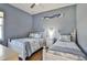 Charming bedroom showcasing two twin beds with coordinated bedding and a serene, inviting atmosphere at 8615 59Th E St, Parrish, FL 34219