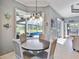 Cozy dining area with views of the screened-in pool and backyard through large windows at 8615 59Th E St, Parrish, FL 34219