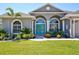 Arched windows and bright blue double doors highlight the entrance of this lovely home at 8615 59Th E St, Parrish, FL 34219