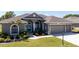 Beautiful home with a three-car garage, arched entryway, and a well-manicured lawn at 8615 59Th E St, Parrish, FL 34219