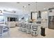 Open-concept kitchen featuring an island with bar seating, pendant lighting, and stainless appliances at 8615 59Th E St, Parrish, FL 34219