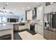 Modern kitchen with stainless steel appliances, an island with bar seating, and a view to the living area at 8615 59Th E St, Parrish, FL 34219