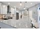Bright kitchen features a large island with granite countertops, modern lighting, and white cabinets and backsplash at 8615 59Th E St, Parrish, FL 34219