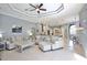 Bright, spacious living room flowing into the kitchen and dining area, with neutral decor and tile flooring at 8615 59Th E St, Parrish, FL 34219